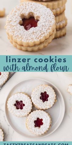 cookies with jam and powdered sugar are on a white plate next to some cookies