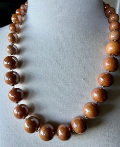 "This Kazuri necklace is 21\" long, earth tone/light brown medium-size beads with a beautiful glaze giving it a nice simmer. Very understated and versatile color. Kazuri beads are made of the special king of the Mount Kenya clay,  handcrafted individually by trained women artisans. They are kiln fired,  glazed, and fired again before being strung. Each piece is unique. By purchasing this creative piece of jewelry you are helping to support a young  Kenyan girl with her educational expenses. 100%  of the profit goes to our Women Children and Education program. Without our support, these young girls have no other means to obtain an education.  We thank you in advance." Kazuri Bead Jewelry, Kazuri Beads, Mount Kenya, An Education, Bead Jewelry, Women Artisans, Earth Tones, Kiln, Kenya