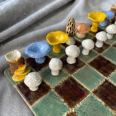 a close up of a chess board with mushrooms on it