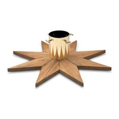 a wooden star decoration with a black candle holder on it's center and bottom