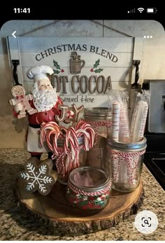 a wooden tray with candy canes and santa clause on it in front of a sign that says christmas blend