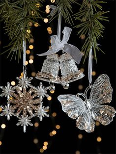 three glass christmas ornaments hanging from a tree