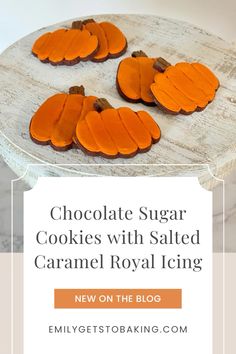 chocolate sugar cookies with salted caramel royal icing on a wooden platter