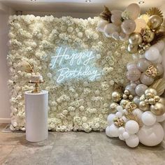 a birthday backdrop with balloons and flowers