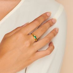 A gorgeous design, this cocktail ring is boldly unexpected. Stunning in its simplicity, the ring features an inlay pear-shaped emerald beautifully set in a gold band that packs a punch. Band is made of 14k gold over sterling silver. Hypoallergenic, nickel and lead free Tarnish resistant H2O sensitive. Before showering or working out, remove your plated jewelry. Clean your piece by buffing gently with a dry cloth and store it in your pouch. Modern Emerald Ring For Anniversary, Modern Emerald Anniversary Ring, Elegant Green Teardrop Emerald Ring, Gold Teardrop Emerald Ring, Gold Pear-shaped Rings With Bezel Setting, Classic Teardrop Emerald Ring As Gift, Pear-shaped Gold Rings With Bezel Setting, Elegant Pear-shaped Green Rings, Gold Emerald Pear-shaped Ring