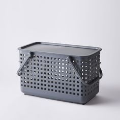 a gray plastic basket with handles on a white background