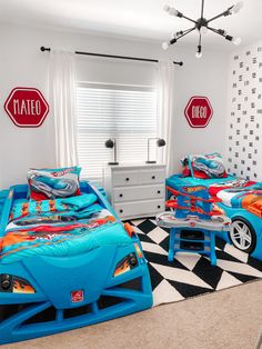 two children's beds with cars painted on them