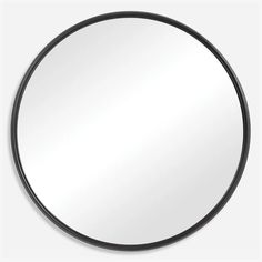 a round mirror with black frame on a white wall, reflecting the light from above