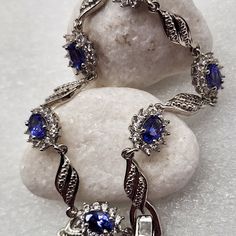 Aaa Tanzanite. White Zircon. Bracelet. (8) In.Platinum Over Sterling Silver. Aaa Tanzanite Ovals (6) Ct.(64) Mm. Prong Set. White Zircon. Rounds. (5.75) Ctw. (5.75) Ctw. Fold Over Clasp. Aaa Tanzanite Color's. Purplish Blues Violet Blues Blueberry. Vivid Vivacious Vibrant Impressive. Gorgeous. No Stacking Required. So Elegant. New. Shipping Box Included. Tiffany Bead Bracelet, Double Chain Bracelet, Zircon Bracelet, Wrap Bangles, Retro Bracelet, Jewelry Logo, Double Wrap Bracelet, Wide Cuff Bracelets, Tory Burch Jewelry