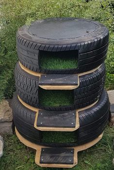 four tires stacked on top of each other in the grass