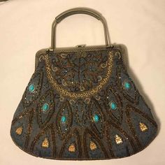 DENIM EMBROIDERED BOHO BAG

BRASS FRAME BAG WITH BOTH METAL HANDLES AND CHAIN SHOULDER STRAP

EMBELLISHED WITH SPARKLING GLASS BEADS ON BOTH SIDES AND FRONT HAS 6 FAUX TURQUOISE CABOCHONS INSET IN BRASS

BRASS SNAP CLOSURE

11" WIDE X 9.5" HIGH X 1" DEEP

DELIGHTFUL FUN BAG

Please view all pictures carefully as they give needed detail. 
 
Feel free to contact me with any and all questions before making your final decision to purchase. All items are listed as used/pre-owned and/or in vintage con Vintage Rectangular Bags With Gold Embroidery, Vintage Blue Embroidered Bag, Vintage Embroidered Pouch Bag, Vintage Embroidered Shoulder Bag, Vintage Embellished Pouch Bag, Vintage Embroidered Travel Satchel, Vintage Embroidered Shoulder Bag For Everyday Use, Vintage Embroidered Handheld Shoulder Bag, Vintage Embroidered Rectangular Satchel