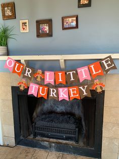 a mantle with a sign that says our little turkey