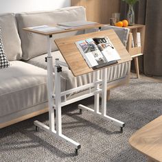 a white couch sitting next to a wooden table on top of a carpeted floor