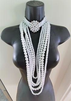 "Hello, welcome to Ken's Closet Today we have a beautiful Peral Body Crystal Choker Necklace. This necklace has 3 strands of pearls on the choker. The choker has a beautiful ornament, that is a mix of pearls and crystals. The necklace is 15\" long with a 2\" adjustable chain. The total length that would hang in the front is 19\" The dangling section is made of 5 stands in different size pearls and staggered lengths. This set is very sparkly and would look great on any stage or special event. Cry Costume Multi-strand Pearl Necklace For Party, Multi-strand Pearl Necklace For Party, Silver Crystal Necklace, Jewelry Royal, Body Necklace, Crystal Choker Necklace, Necklace Diamond, Crystal Choker, Silver Crystal