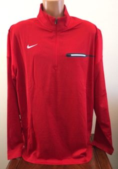 We love to combine shipping!  ~ Nike ~  Men's 1/2 Zip Pullover Shirt Style: 746960 - Color: 658 Red - Size: 2XL ~ Brand New with Tags ~ Mock neck 100% Polyester exclusive of decoration Dri-FIT helps pull sweat away to keep you dry and comfortable 1/2 zip Front left chest zip pocket Armpit to armpit measures approx. 27" Armpit to end of sleeve approx. 21.5" Armpit to hem approx. 19.25" Back neck seam to hem approx. 30.5" Side neck seam to end of sleeve approx. 33.25" I want my Nike Casual Top In University Red, Casual Half-zip Sports Tops, Casual Red Sports Tops, Nike Sporty Tops In University Red, Nike Sporty University Red Tops, Red Long Sleeve Sports T-shirt, Casual Long Sleeve Sports Shirt, University Red Long Sleeve Sporty Tops, Nike Casual Long Sleeve Shirt