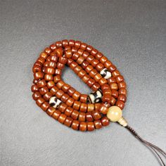 ❤This mala was made by Tibetan craftsmen and come from Hepo Town, Baiyu County, the birthplace of the famous Tibetan handicrafts.It is made of yak bone, brown color,108 dice beads diameter of 10mm / 0.4",circumference is 84cm / 33",and 3 dzi beads,end of a yak horn guru bead.❤DETAILS100% HandmadeMaterial:yak bone,yak horn,dzi beadSize:Mala Circumference:84cm/ 33 inch108 × yak bone beads, size:10mm/ 0.4 inch1 × 3 eyes mandala dzi bead, size:15 × 12mm/ 0.6 × 0.47 inch2 × tiger tooth dzi beads, siz Traditional Red Mala With Round Beads, Traditional Hand-strung Black Mala, Traditional Black Hand-strung Mala, Traditional Brown Hand-strung Mala, Brown Wooden Beads Spiritual Mala, Tiger Tooth, Lotus Sutra, Nothing Is Permanent, Buddhist Teachings