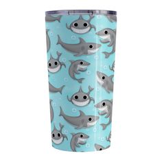 a blue cup with dolphins and sharks on it