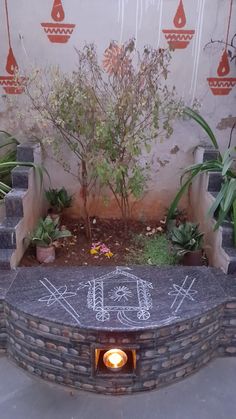 a stone bench with chalk writing on it in front of a wall that has plants and flowers