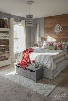 a bedroom with a bed, dressers and rug on the floor in front of it