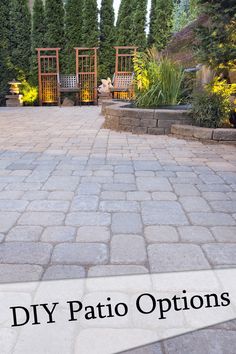 an outdoor patio with stone pavers and trees