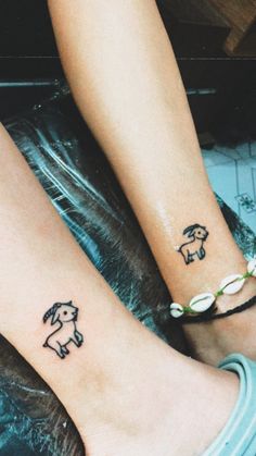 two people with matching tattoos on their feet, one has an elephant and the other has a dog