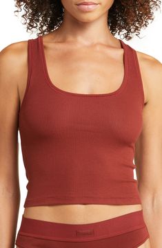 A tried-and-true classic, this scoop-neck tank that's made to layer with ribbed stretch cotton is from Kim Kardashian's highly sought-out SKIMS. Available in a wide range of colors, this comfortable style that hits right at the natural waist for a no-fuss, no-tuck fit is destined to be a part of your regular lounge rotation. 17" length (size Medium) Scoop neck 95% cotton, 5% spandex Hand wash, dry flat Imported Comfortable Fitted Ribbed Tops, Comfortable Ribbed Fitted Tops, Seamless Cotton Tops For Lounging, Ribbed Cotton Tank Top For Workout, Ribbed Cotton Workout Tank Top, Casual Seamless Tops For Lounging, Solid Ribbed Top For Lounging, Ribbed Cotton Workout Top, Casual Cotton Tank Top For Lounging