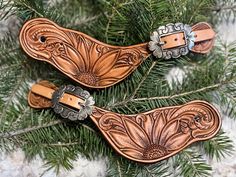 two wooden ornaments hanging from a christmas tree