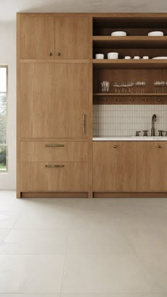 a kitchen with wooden cabinets and white tile flooring