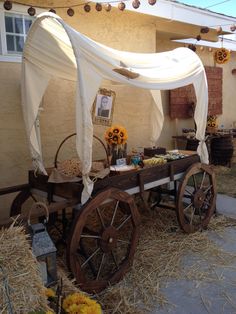 an old wagon is decorated with sunflowers and other things for the guests to eat