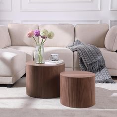 a living room filled with furniture and flowers on top of a table in front of a couch