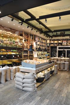 the inside of a store filled with lots of bags and containers full of food on shelves