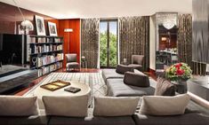 a living room filled with furniture and a flat screen tv