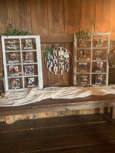 three old window frames are sitting on top of a bench in front of a wood paneled wall