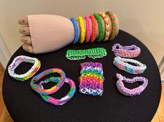 there are many bracelets on the table and one is made out of plastic beads