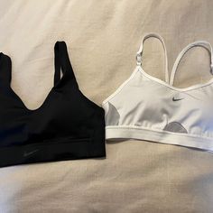 Two Nike Sports Bras Size Medium. The Black One Is Dry Fit, New Without Tags; And The White One Has Been Gently Used. White Sports Bra For Athleisure, Sporty White Training Bra, Sporty White Workout Bra, White Sporty Workout Bra, Sporty White Bra For Workout, Sporty Stretch White Bra, White Racerback Workout Bra, White Athleisure Bra For Workout, White Activewear With Built-in Bra For Sports