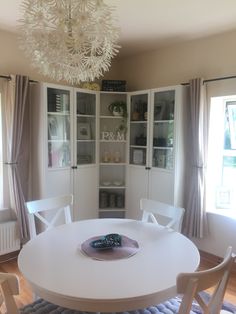 a white dining room table with chairs around it