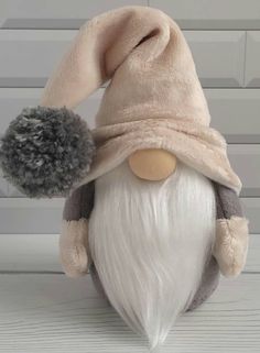 a stuffed toy gnome with a hat on it's head