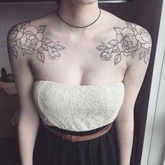 a woman with tattoos on her chest wearing a dress