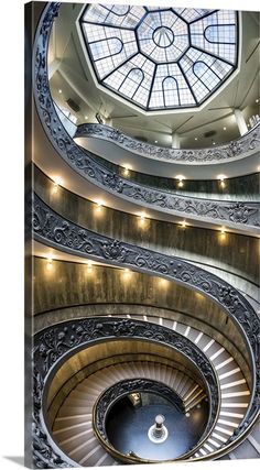 a spiral staircase with a skylight above it