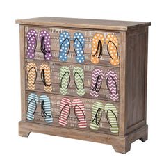 a wooden cabinet with flip flops painted on the front and bottom drawers, all decorated in multicolored polka dots