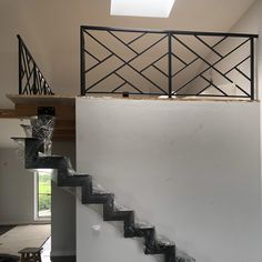 a stair case with glass vases on the bottom and an open window above it