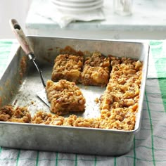 a metal pan filled with food on top of a table