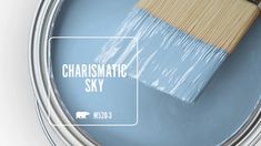 a blue paint can with a wooden brush in it and the words charismatic sky above it