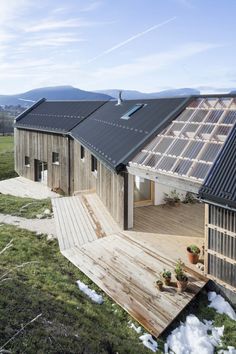 a wooden house with a metal roof in the mountains