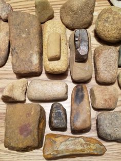 several different types of rocks laid out on a wooden surface