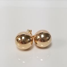 "Thanks for shopping our vintage estate store. We tend to sell well below wholesale and truly hope you enjoy all of our items. Many of the items are one of a kind, so please enjoy scrolling through the pictures and hopefully something will catch your eye. Brown spots are from camera. Nice estate 14k yellow gold ball earrings studs. They are nice and I assume they are hollow, but durable. Size: 10mm 1/2\" Weight: .96 gram Earring backs are included and studs are marked 14k. Didn't see any dings o Hallmarked 14k Gold Round Earrings, Classic Round 14k Gold Clip-on Earrings, Classic Yellow Gold Round Plug Earrings, Classic Round Yellow Gold Plug Earrings, Classic Polished Earrings For Anniversary, Classic Polished Finish Earrings For Anniversary, Stamped 14k Gold Round Earrings, Classic Anniversary Earrings With Polished Finish, Anniversary 14k Gold Polished Earrings