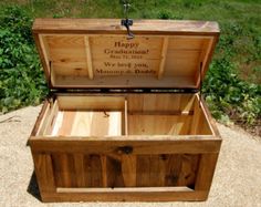 an open wooden chest sitting on top of a gravel field