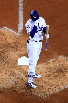 a baseball player holding a bat on top of a field