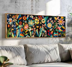 a painting hanging on the wall above a couch