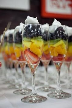 fruit salad in wine glasses on a table